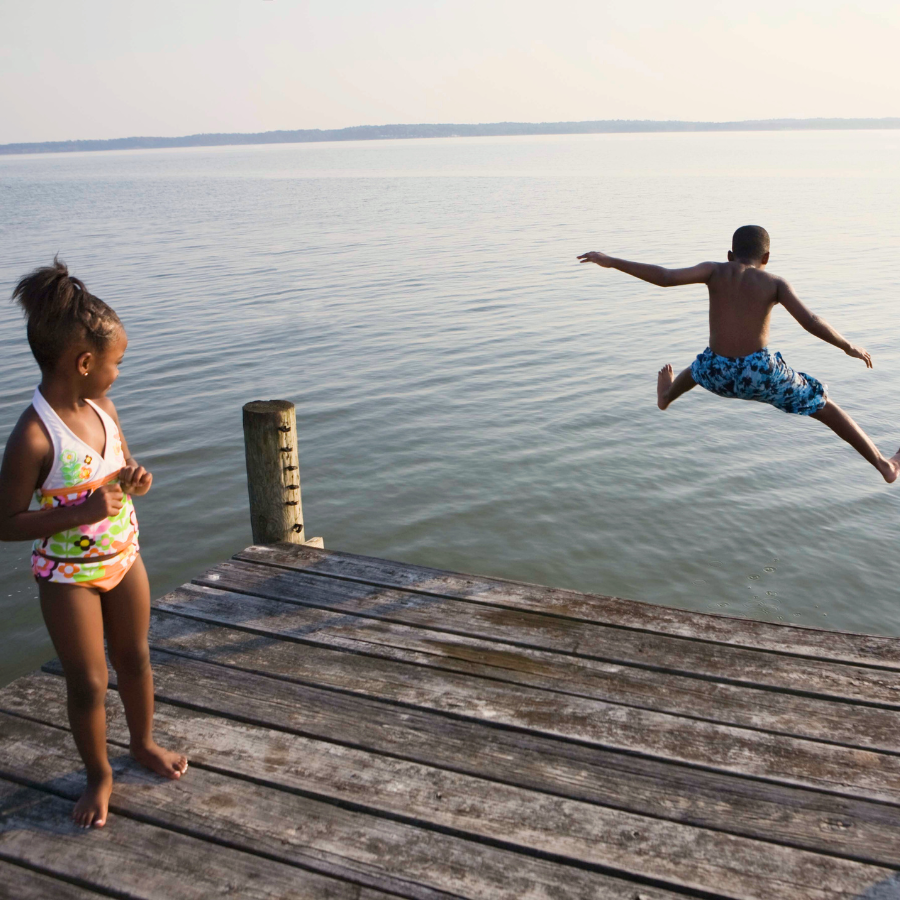 Child jumping off dock