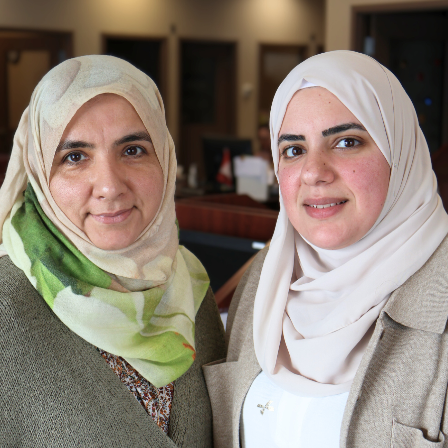 Smiling students from Spanish Club standing in a school gym