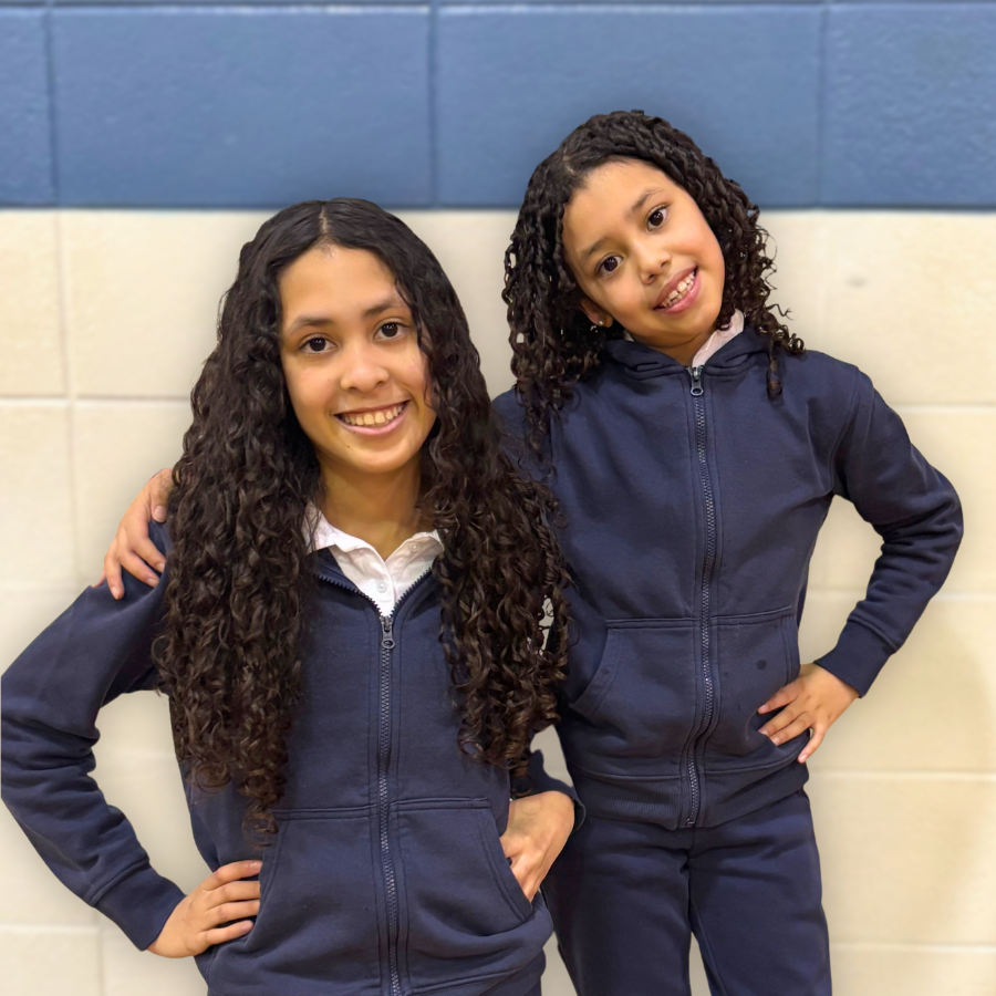 Smiling students from Spanish Club standing in a school gym